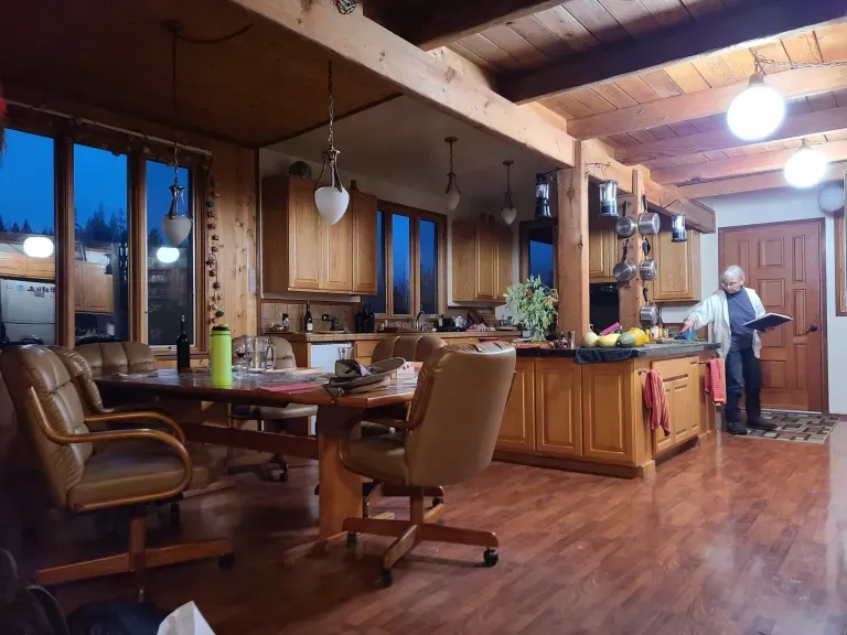 A view of the kitchen and dining room in the main cabin. Jim’s favorite chair pictured farthest.